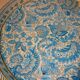 Blue cashmere round tray on white background.