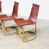 Set of four leather and brass Italian dining chairs