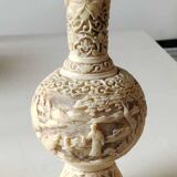 Asian-inspired ball vase. In beige cinnabar lacquer. Scenes of life decor. Arabesque and floral friezes. Height 24 cm