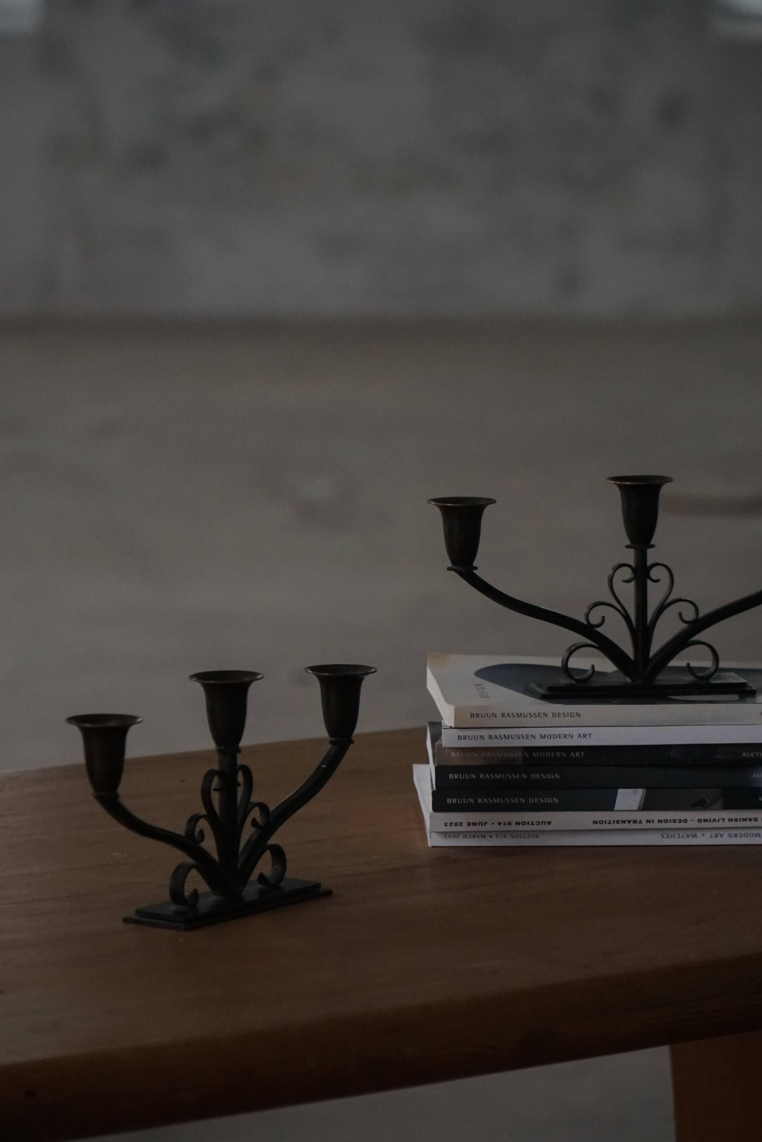 Early 20th century, pair of Danish Art Deco candlesticks in metal with three arms, 1930s.