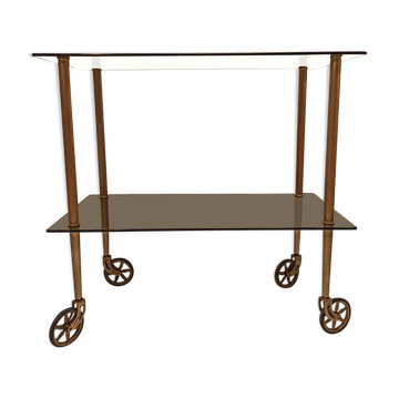 Vintage rolling dessert trolley with smoked glass trays and a golden base.