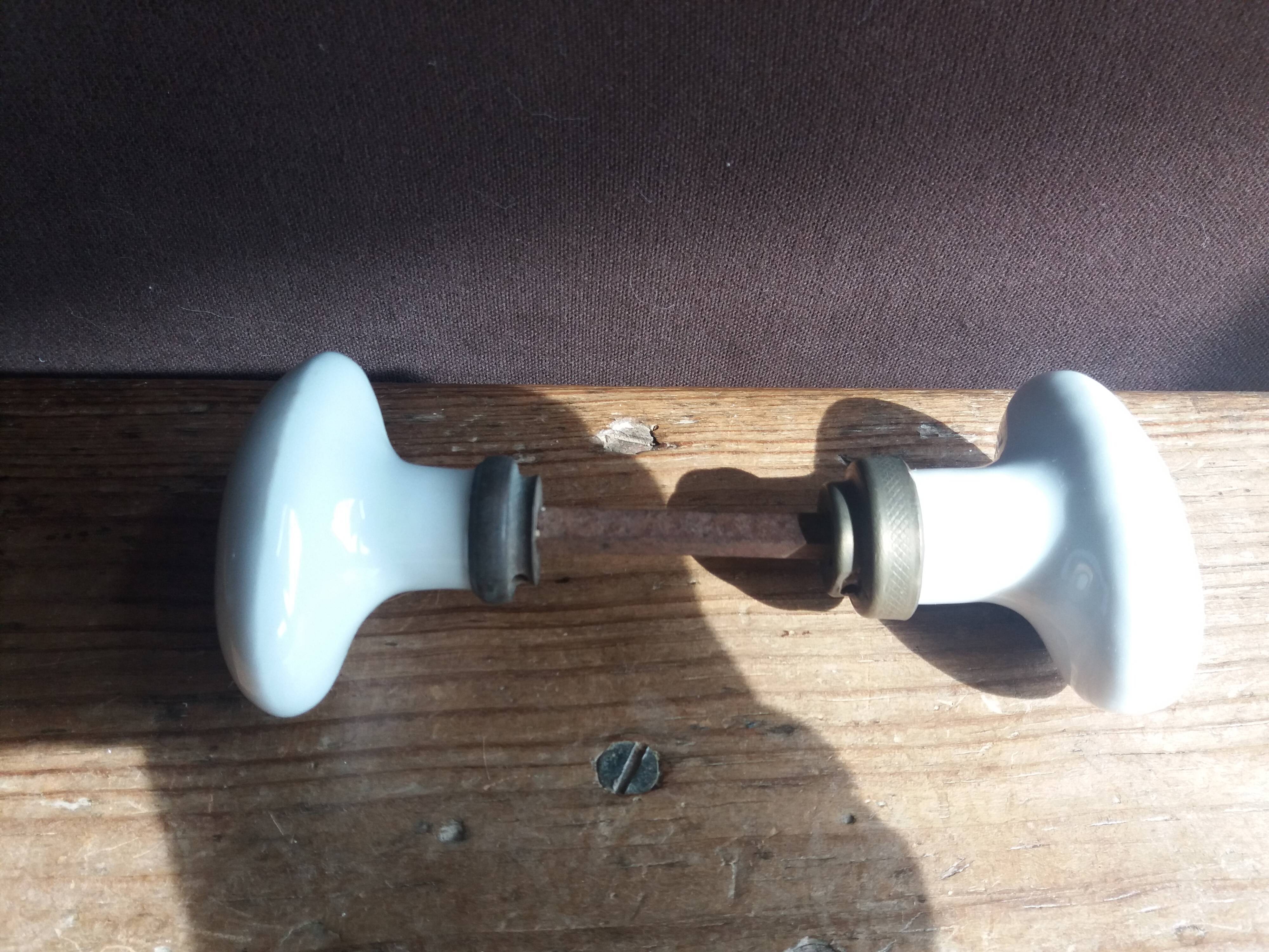 White porcelain door knob handles