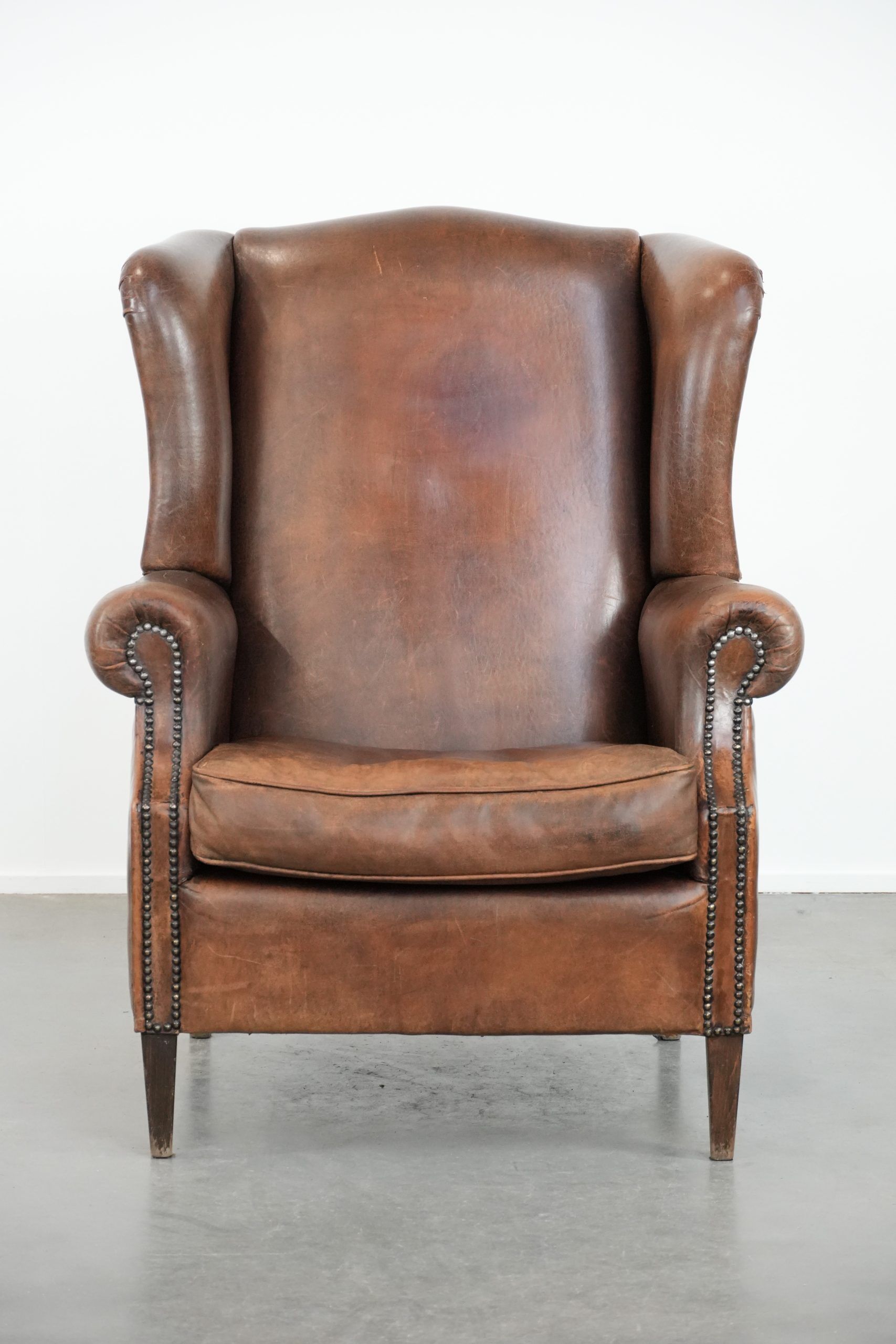 Vintage wingback armchair made of sheepskin leather with beautiful colours