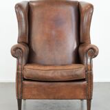 Vintage wingback armchair made of sheepskin leather with beautiful colours
