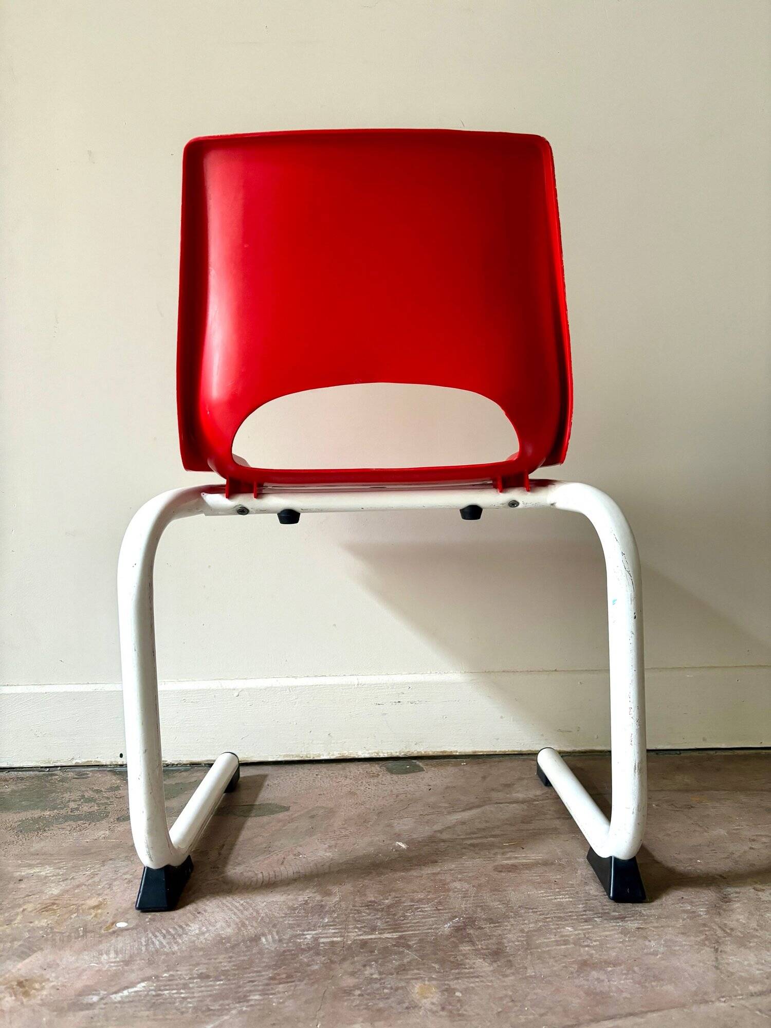 Children's chair in white metal and red plastic