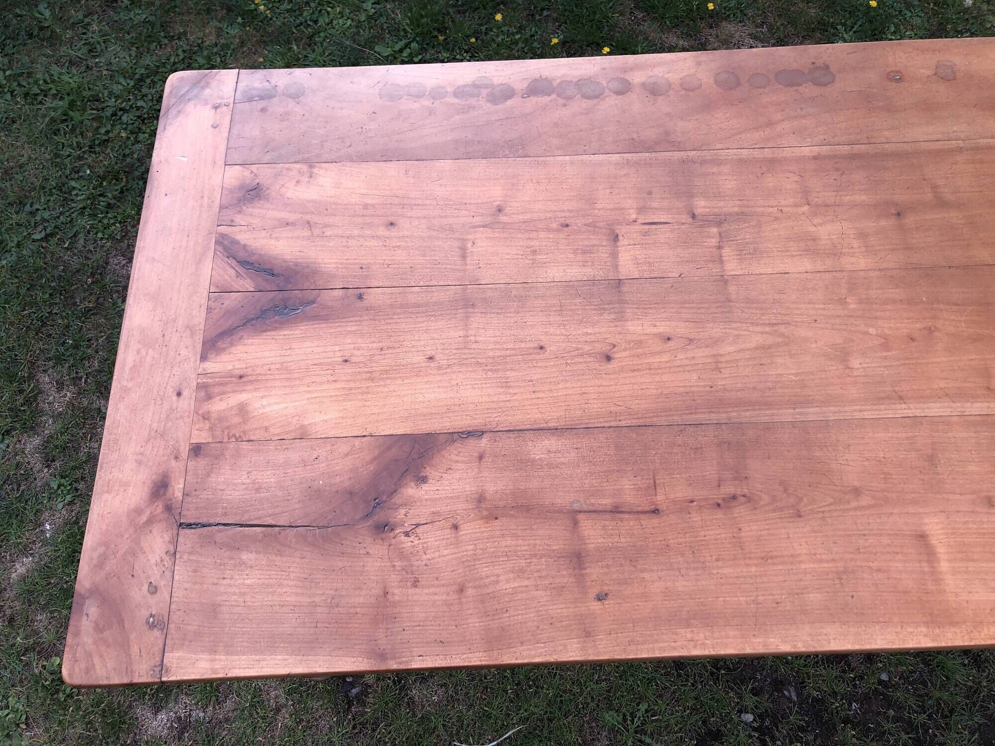 Antique farmhouse table in solid cherry wood with 2 drawers and 1 pull-out at the end with turned legs.