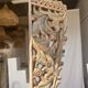 Indonesian construction element in carved wood with intertwined plant motifs mounted on a base (fri