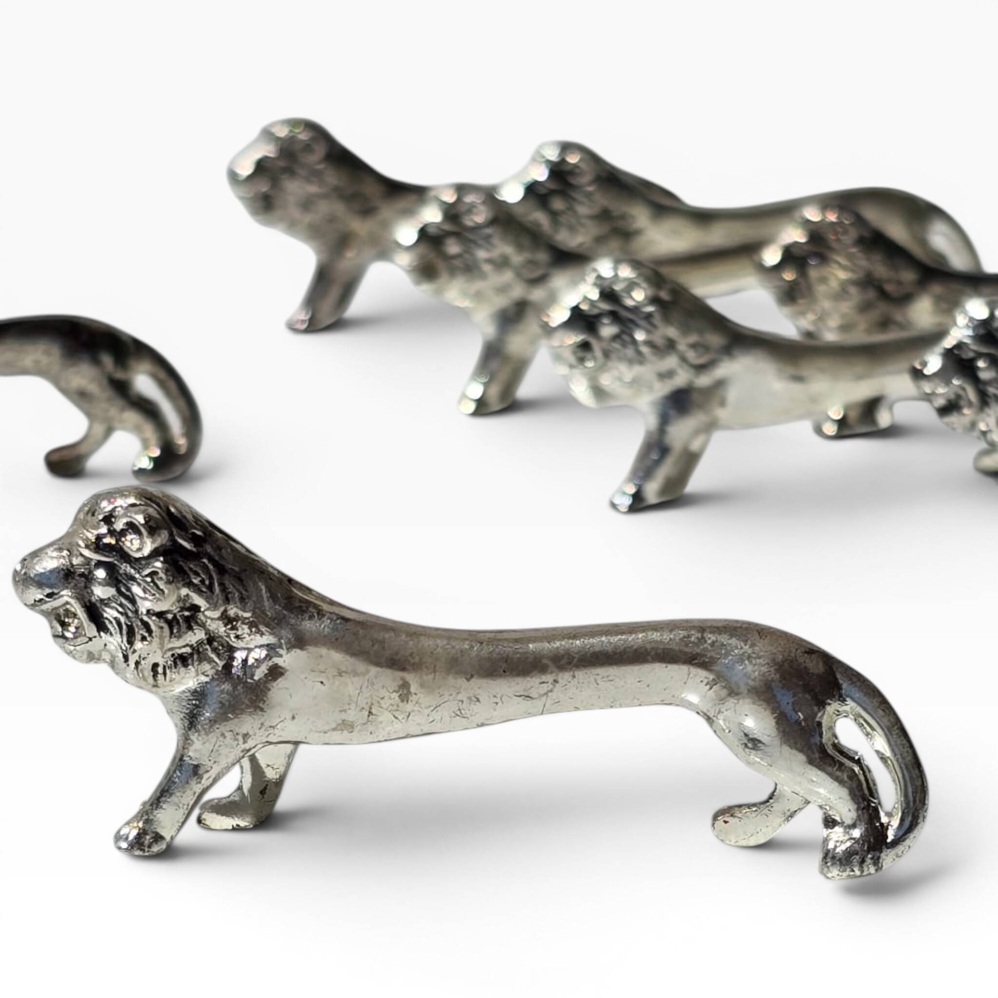 Series of antique knife rests in the shape of a lion, silver-plated metal.