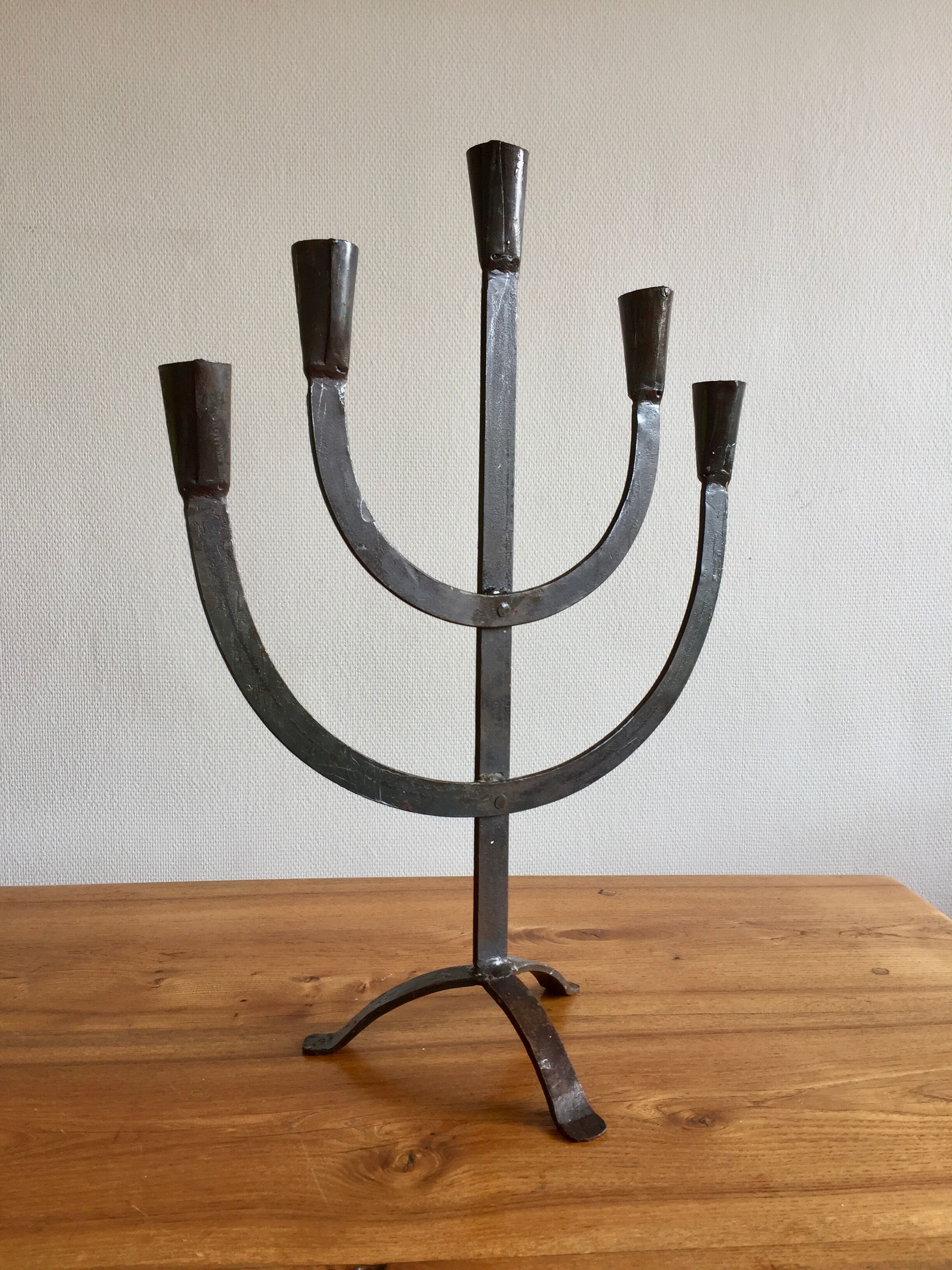 Old iron candelabra shaped high time
