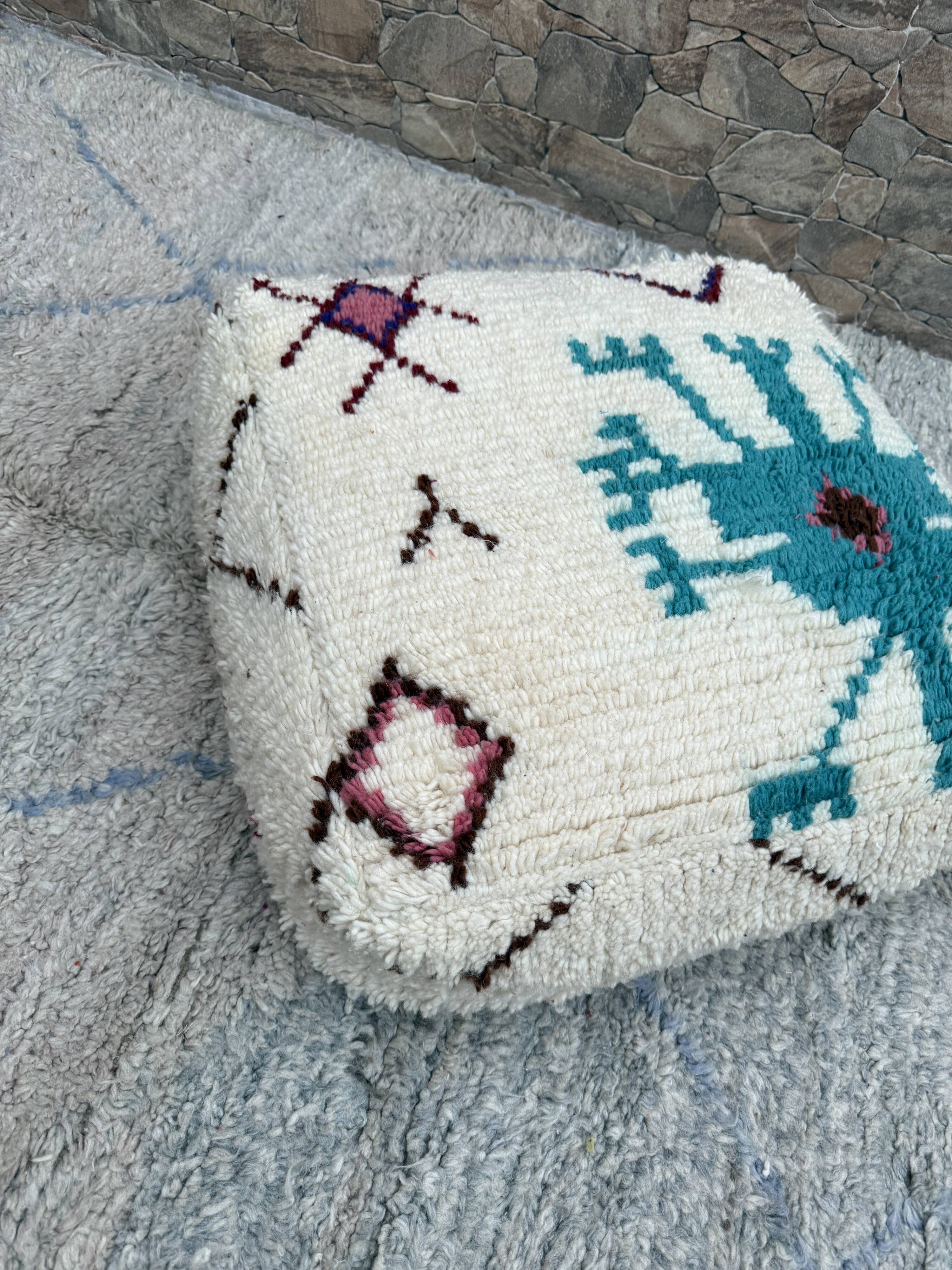 Berber floor pouf: Handwoven Moroccan wool cushion.