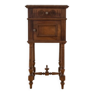 Antique wooden bedside table with a marble top.