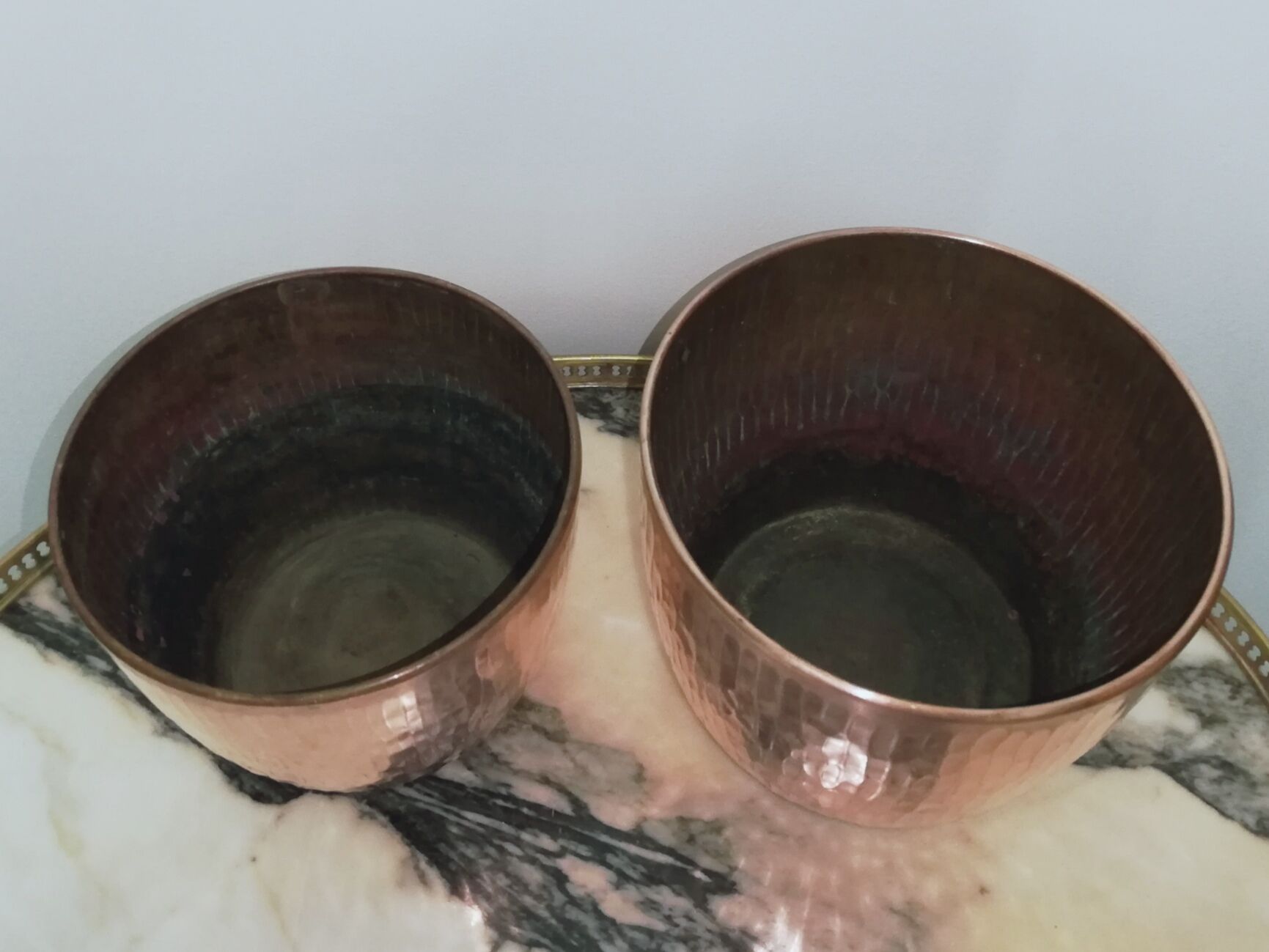 Duo of hammered copper pot covers