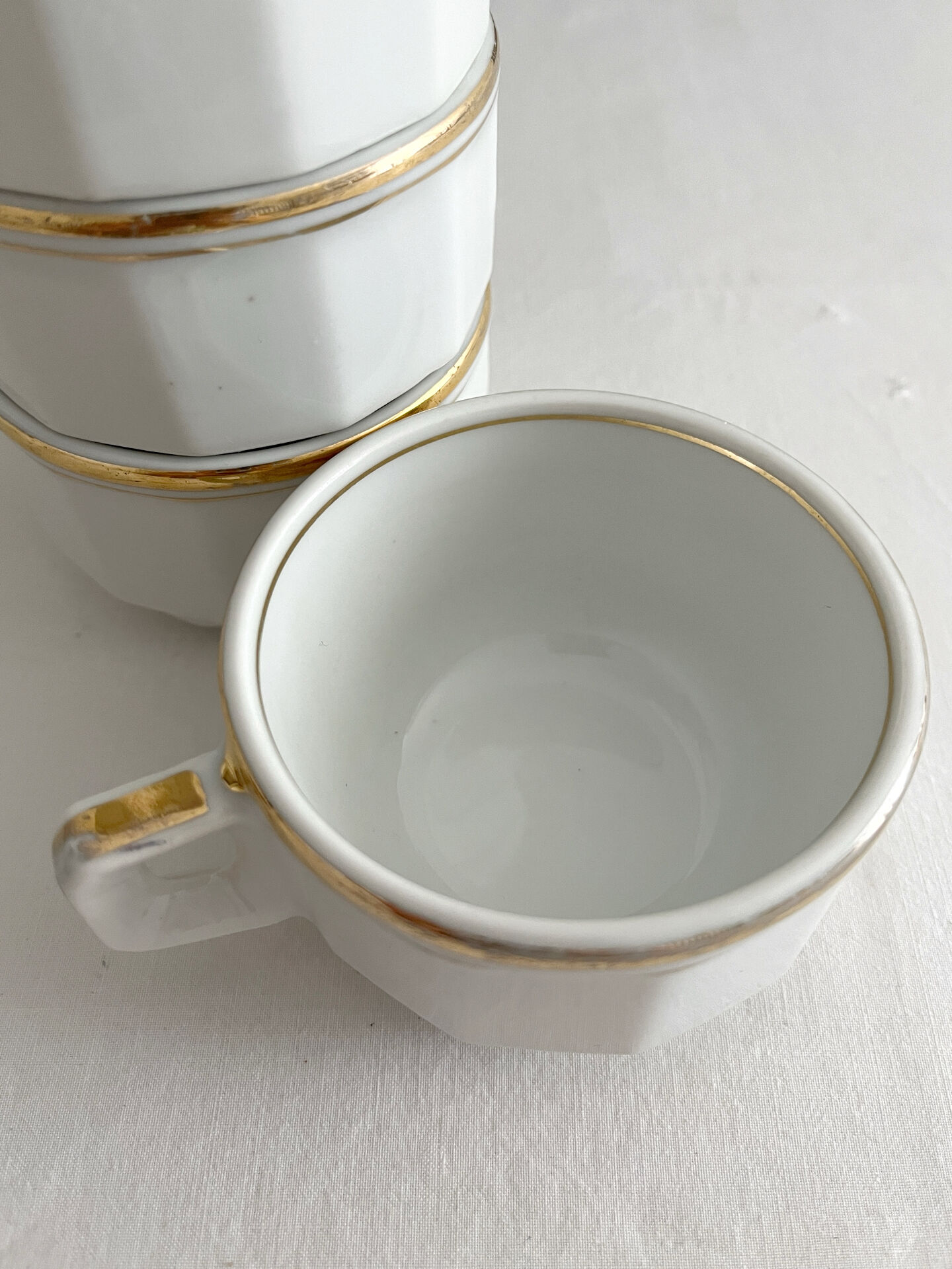 5 vintage porcelain bistro coffee cups from Paris with gold trim.