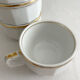 5 vintage porcelain bistro coffee cups from Paris with gold trim.