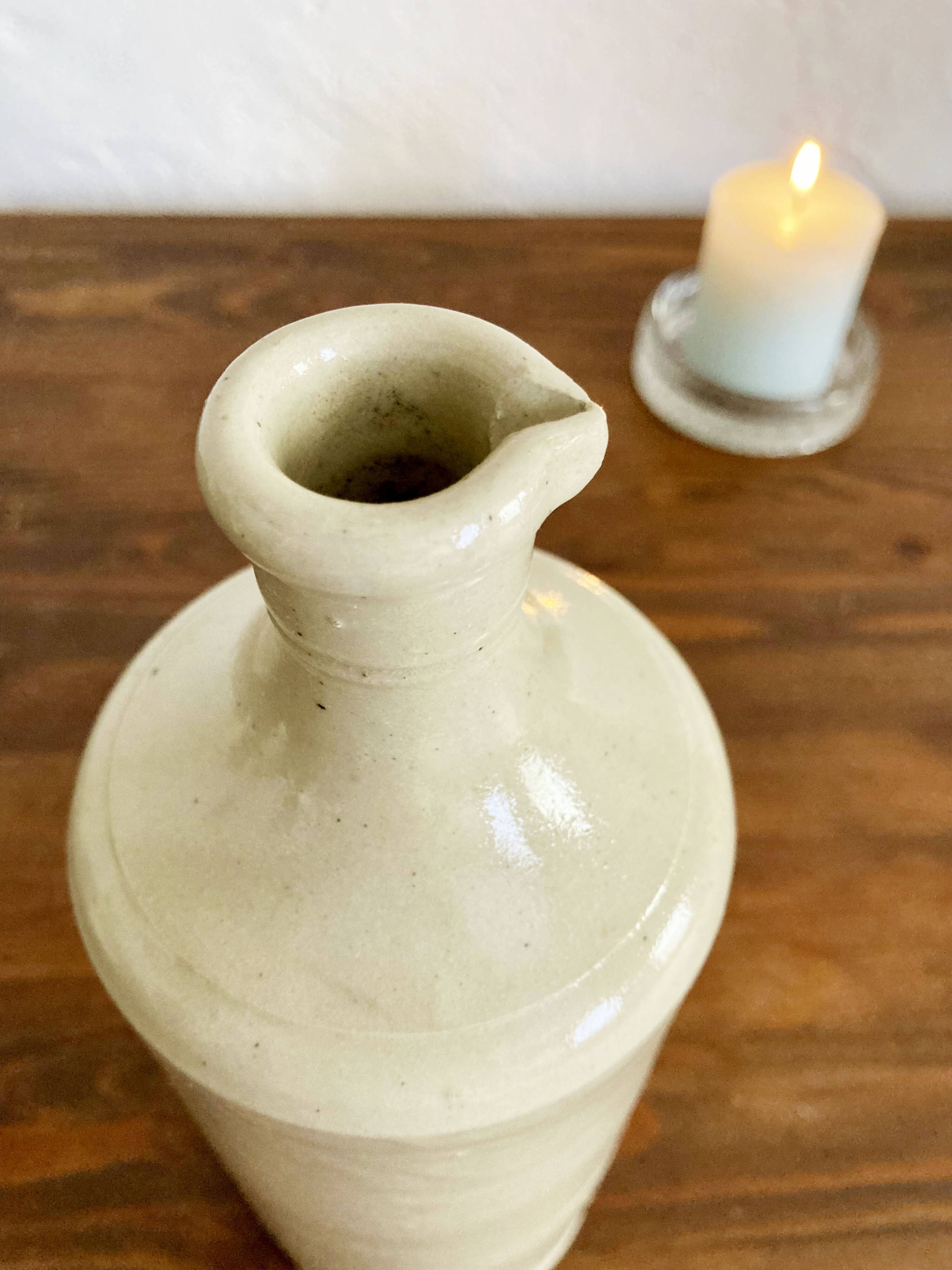 Trio of creamy white glazed stoneware bottles