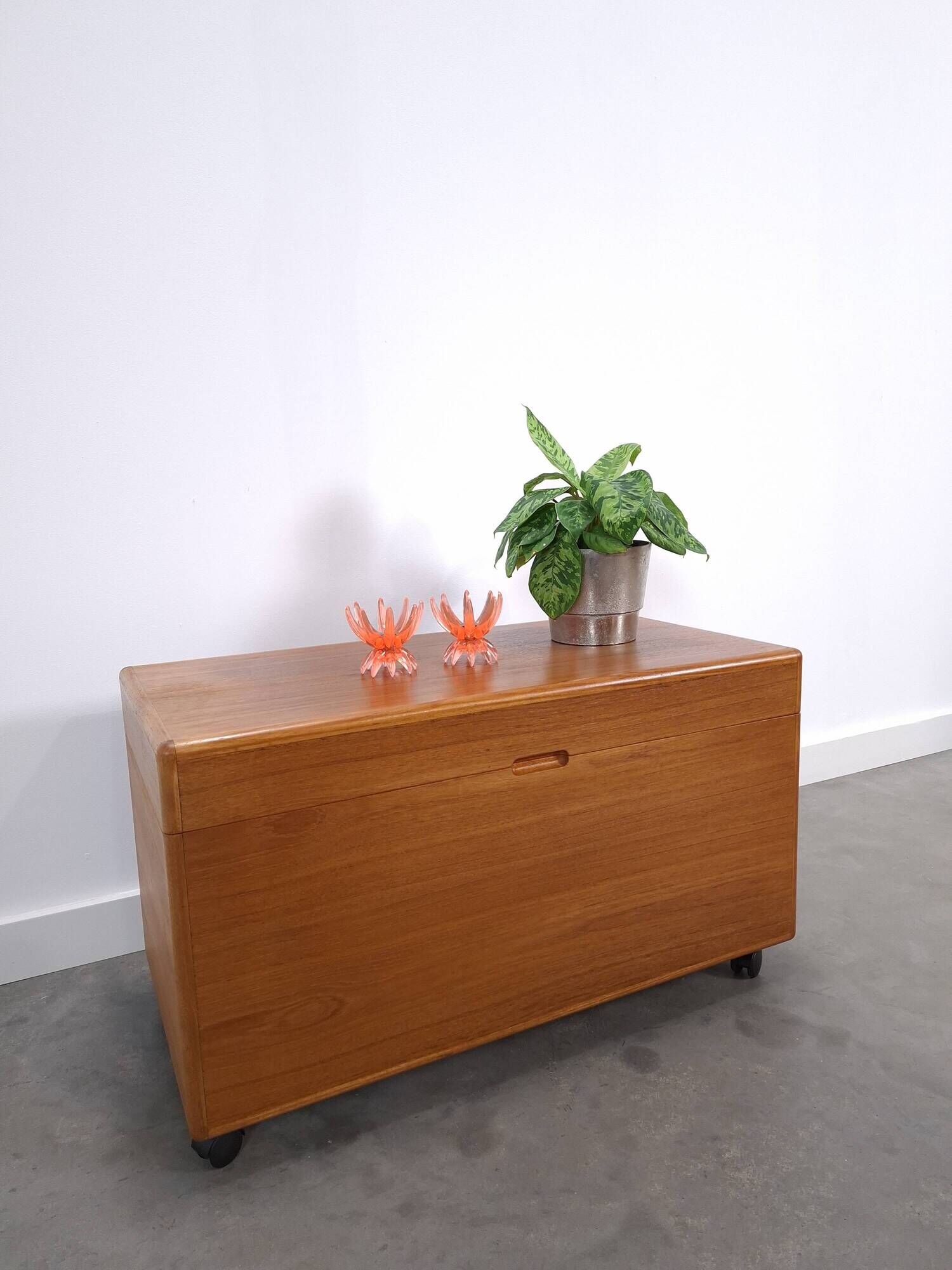 Vintage teak Danish chest with a lid on wheels, toy chest.