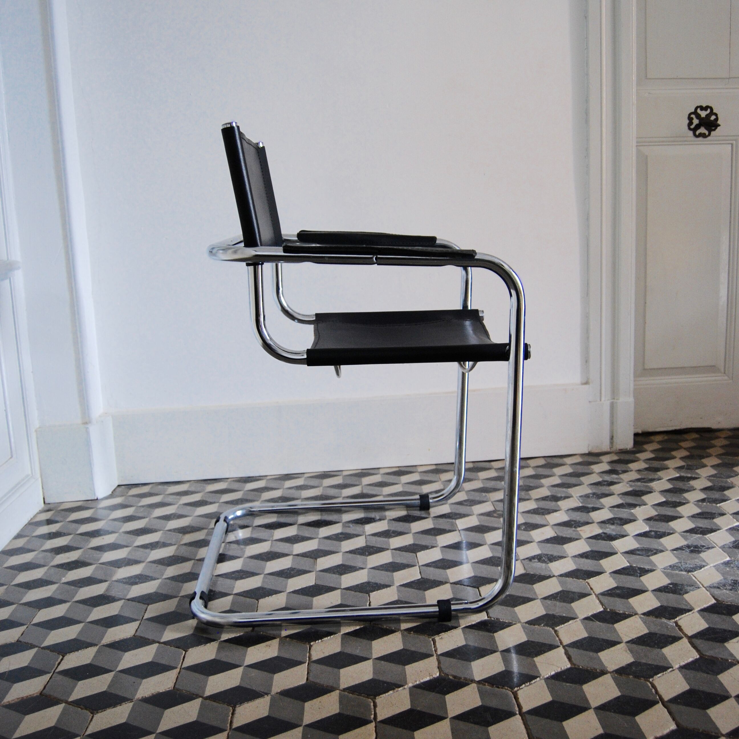 Vintage chrome and faux black leather armchair