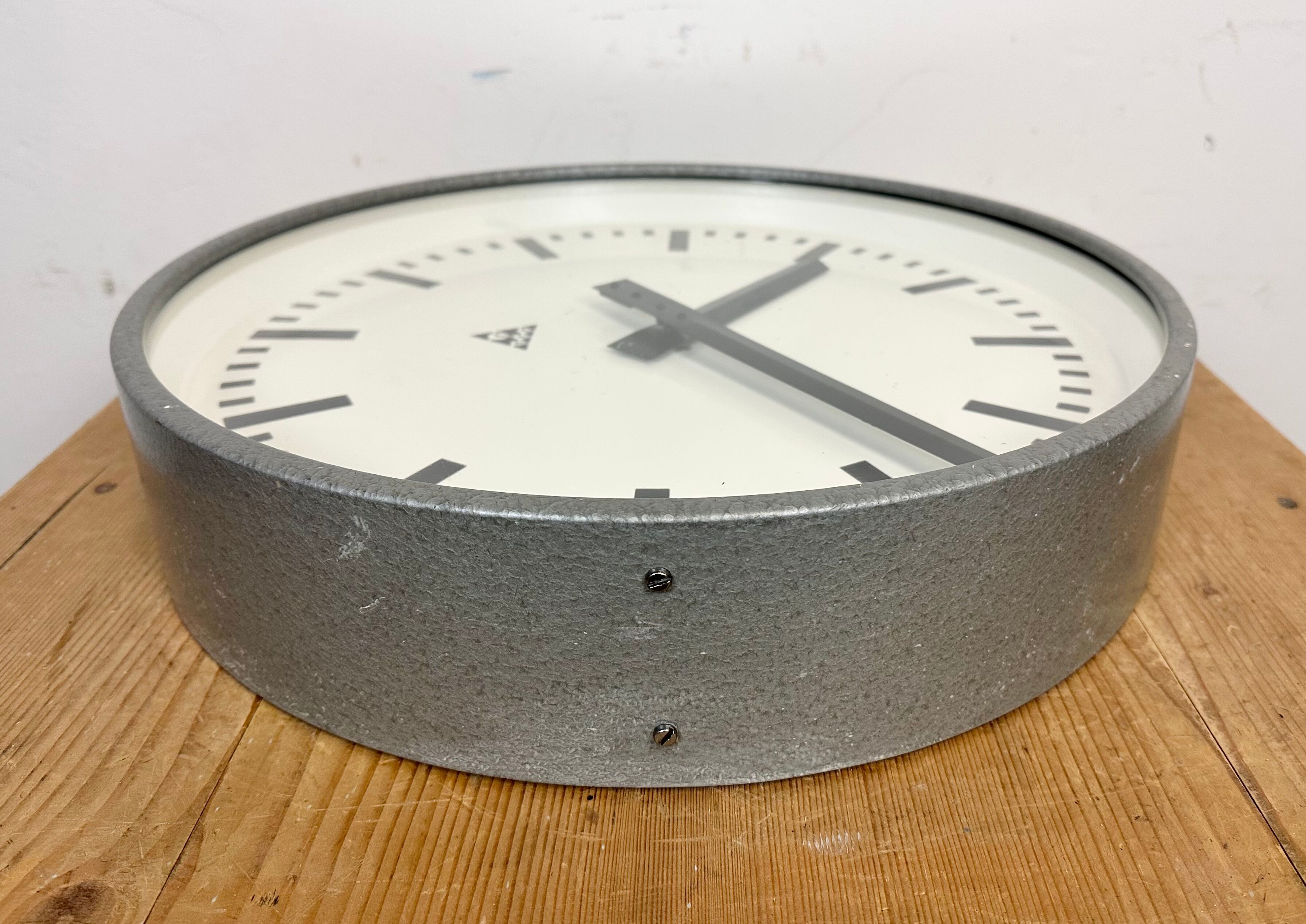 Grey industrial factory wall clock from pragotron, 1960s