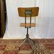 Old high workshop chair made of wood and metal.