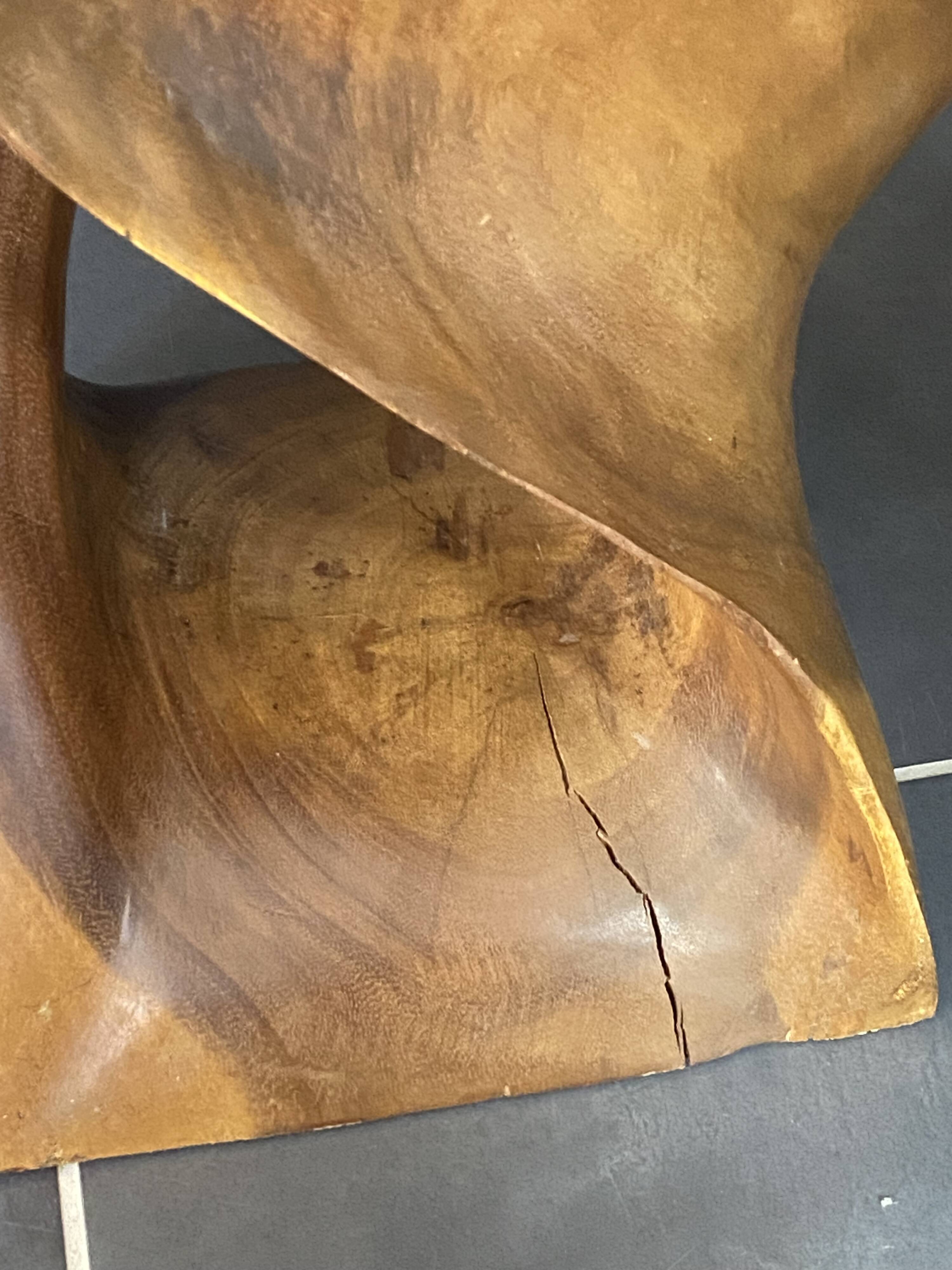 Stool no. 1 in solid raw walnut wood, carved from the mass, 1970.