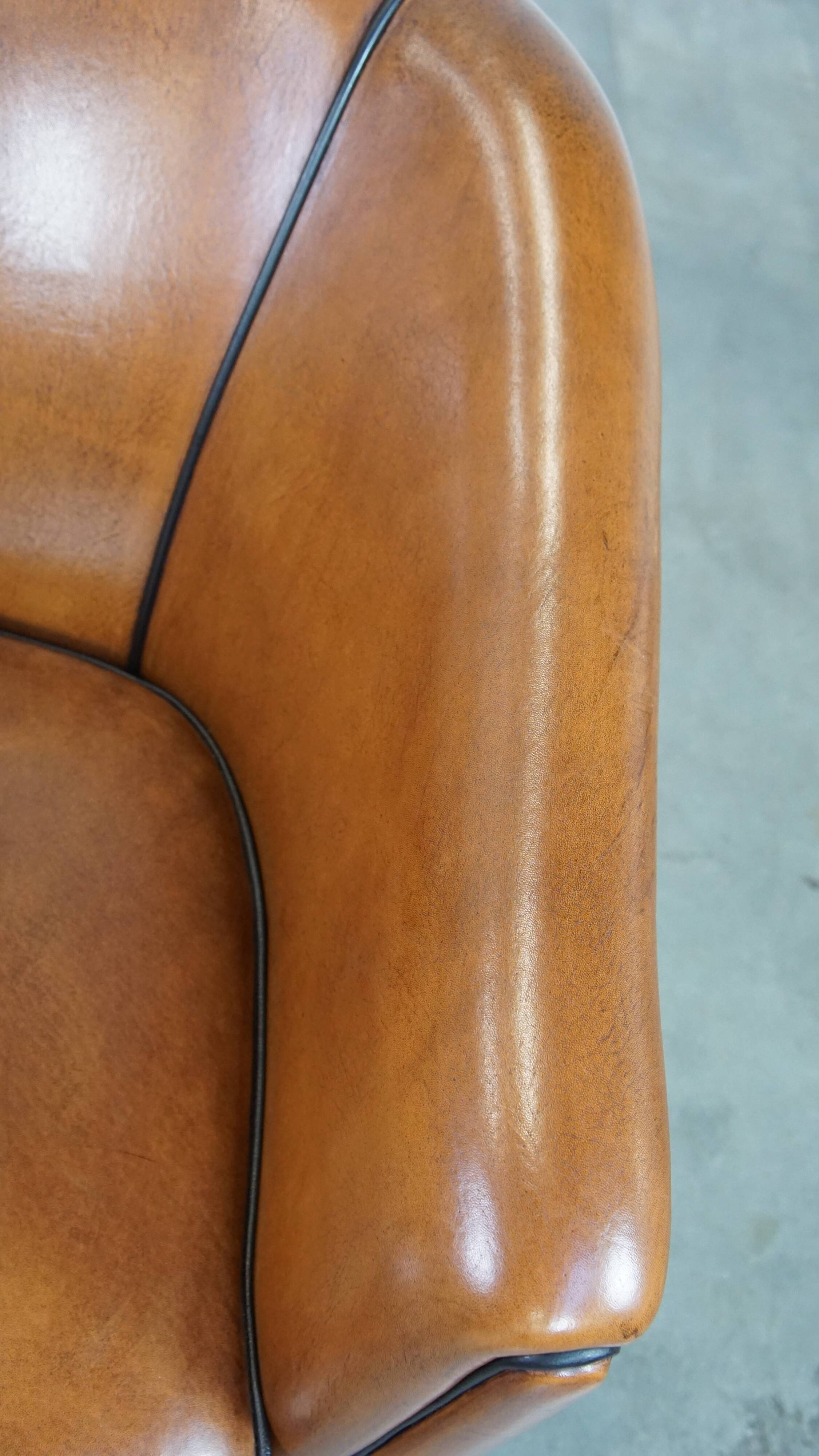Sheep leather club chair finished with black piping