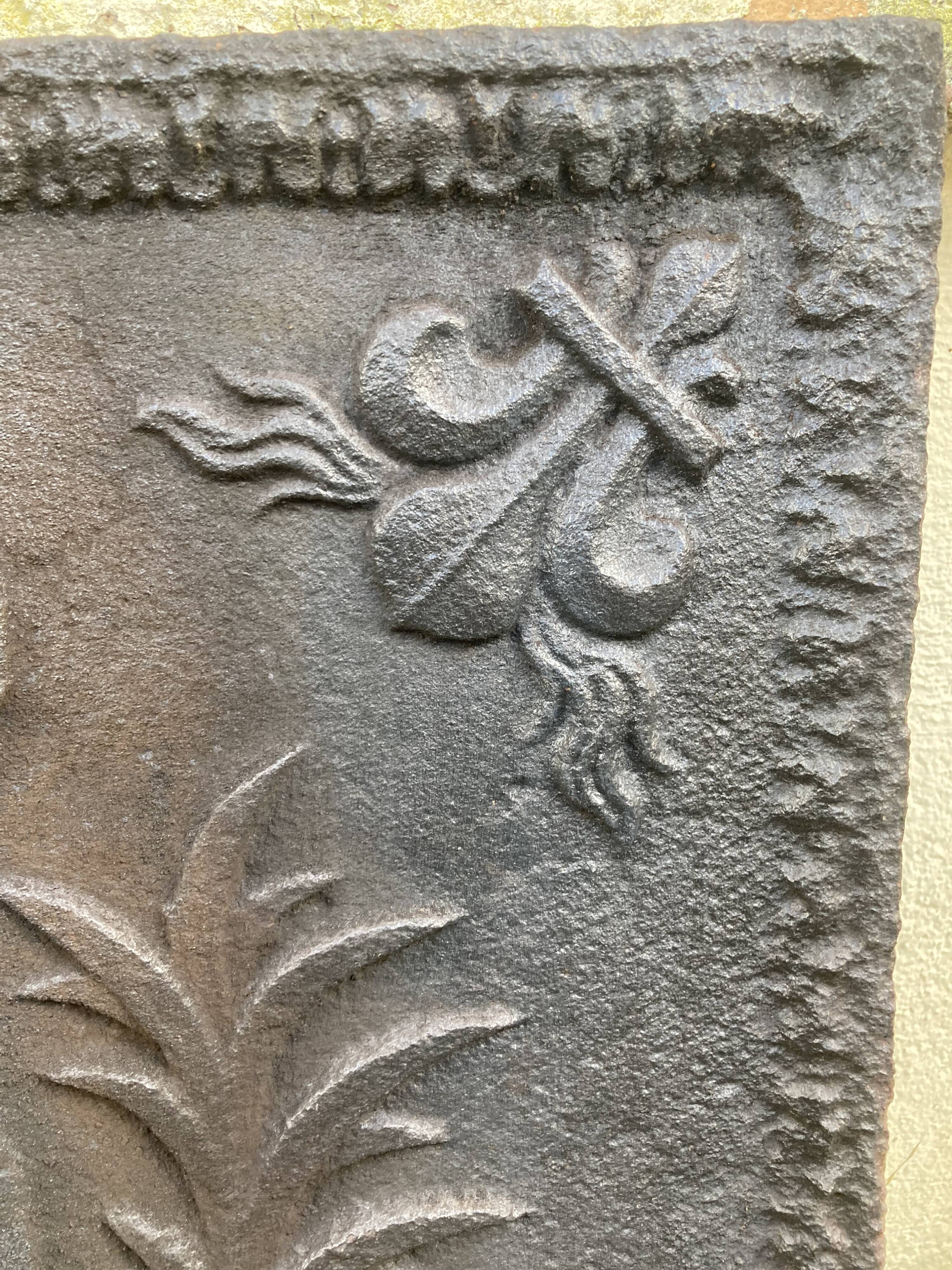 Old cast iron fireback with royal coat of arms