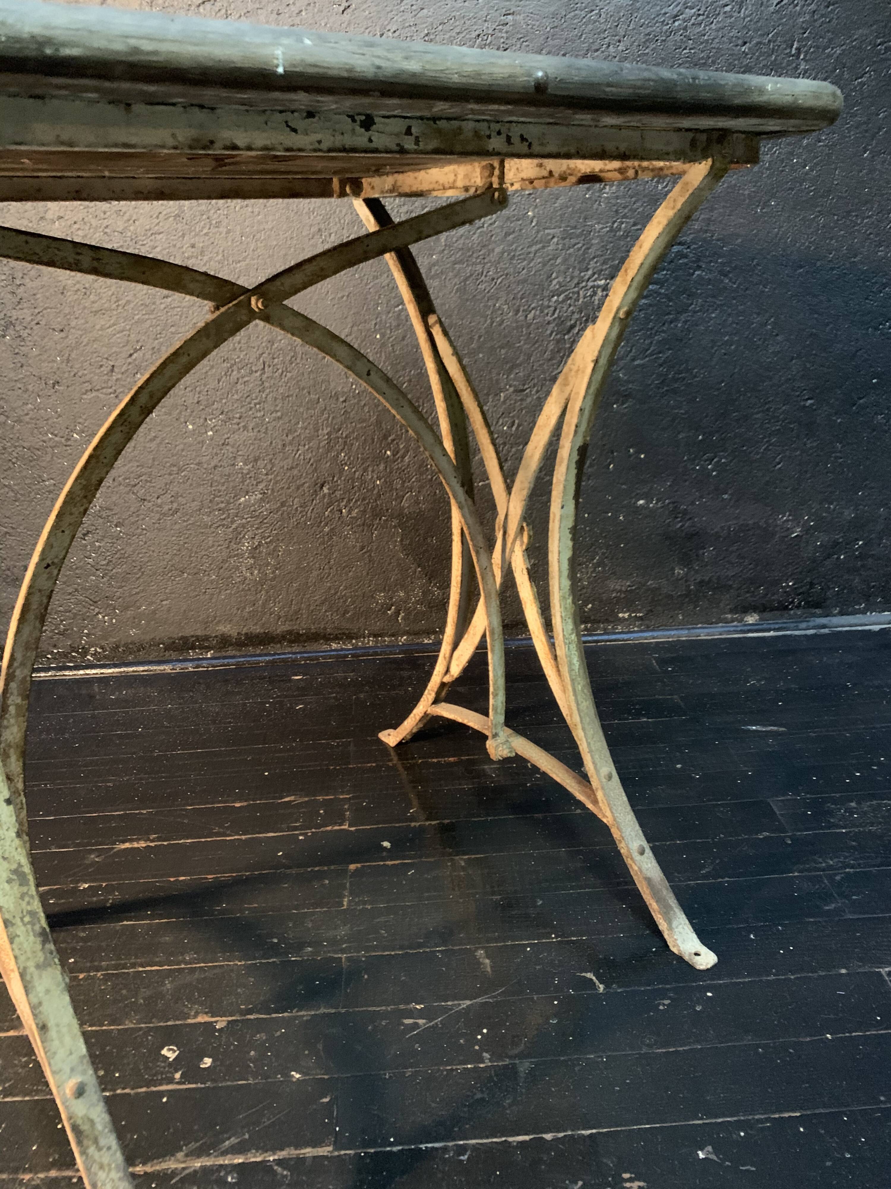 Ancient wrought iron and wood garden table