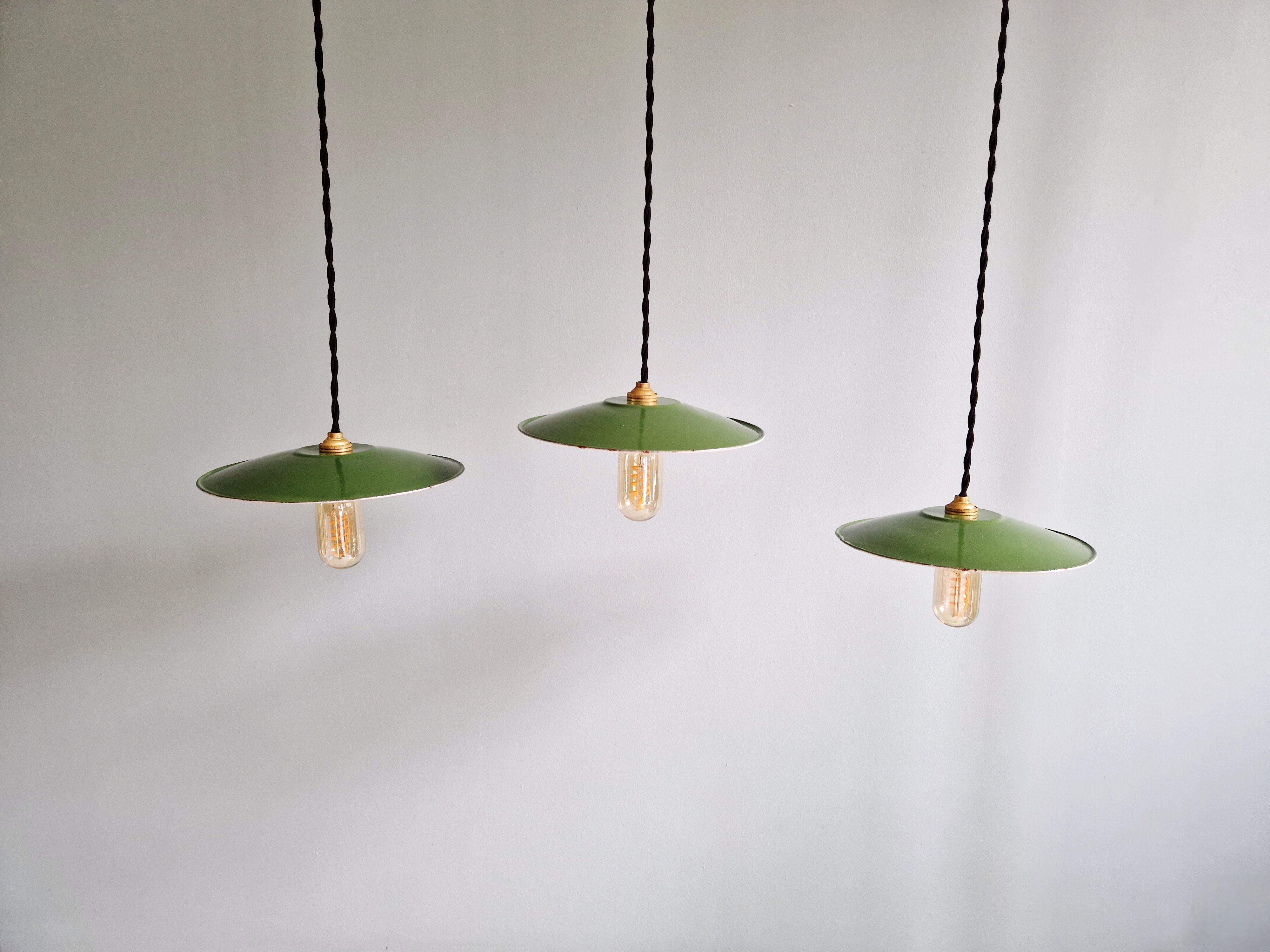 Trio of large industrial suspensions in green enamelled sheet metal.