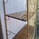 Wall shelf in metal with slanted shelves