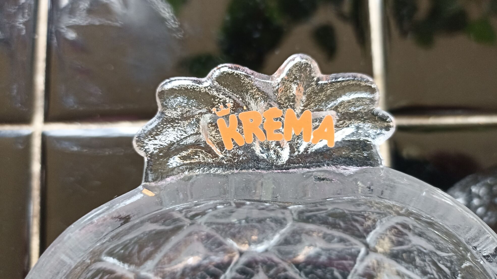 Two molded glass cups in the shape of strawberry and pineapple