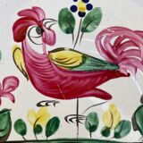 Old plate with flower and rooster pattern