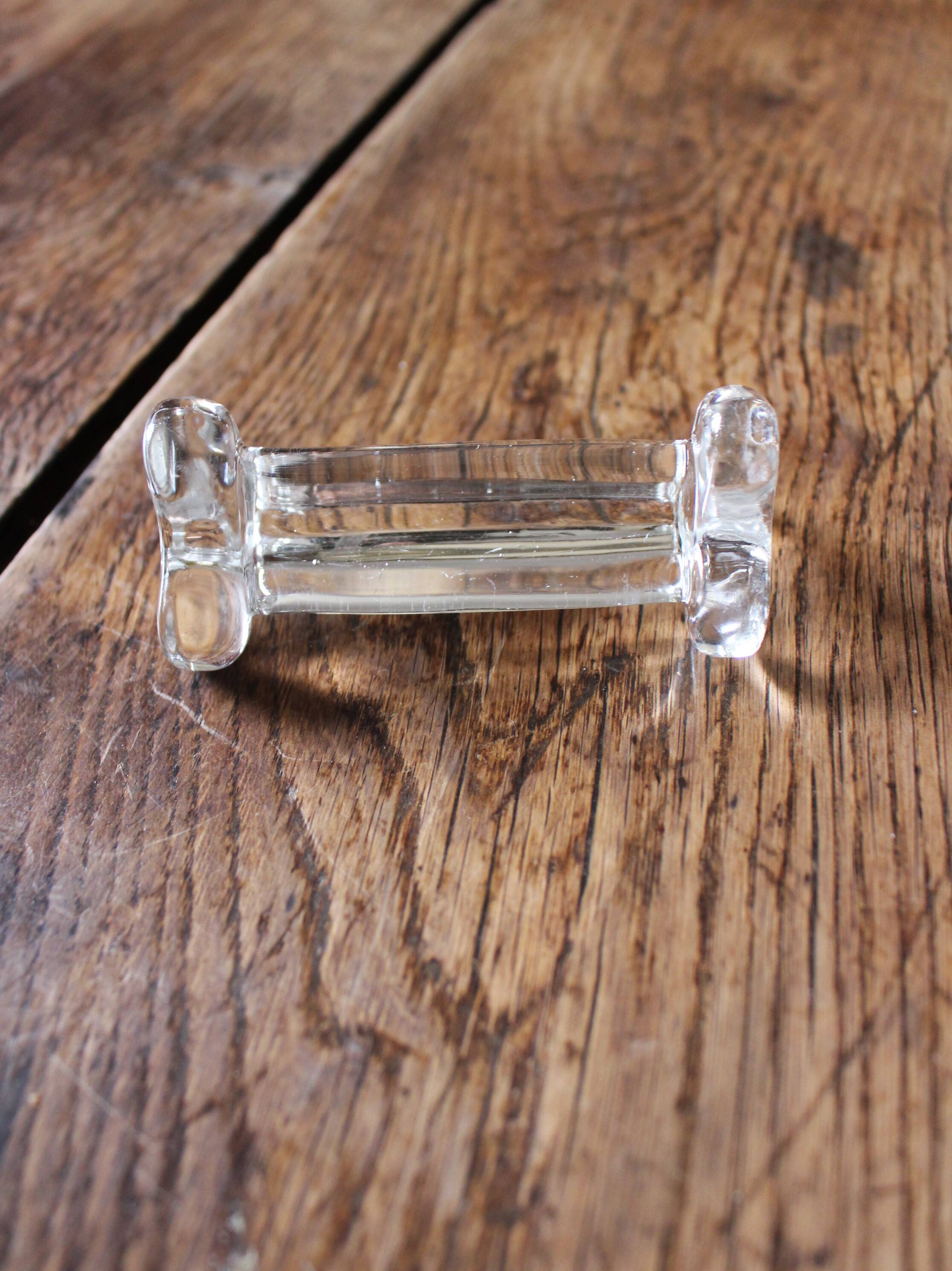 A set of 6 antique transparent trilobed glass knife holders