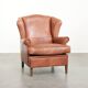 Light cognac-coloured cow leather wingback armchair with matching piping