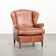 Light cognac-coloured cow leather wingback armchair with matching piping