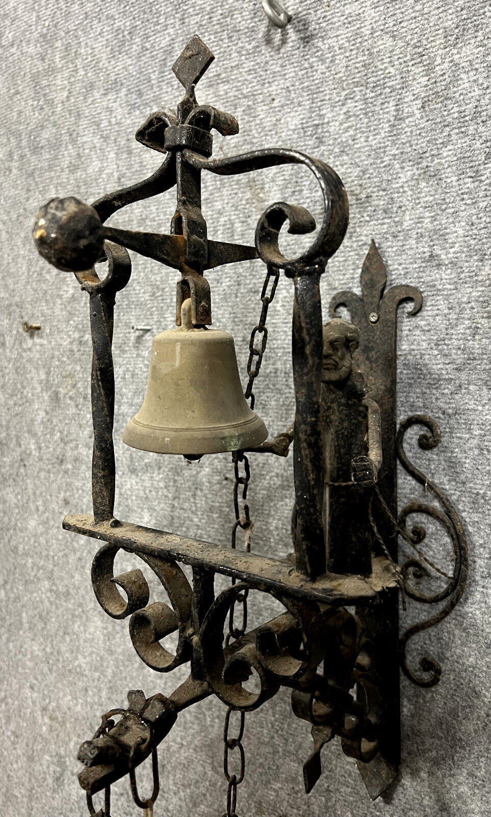 Wrought iron entrance bell depicting a monk ringing a bell circa 1900-1930