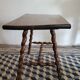 Brutalist coffee table with turned wooden legs