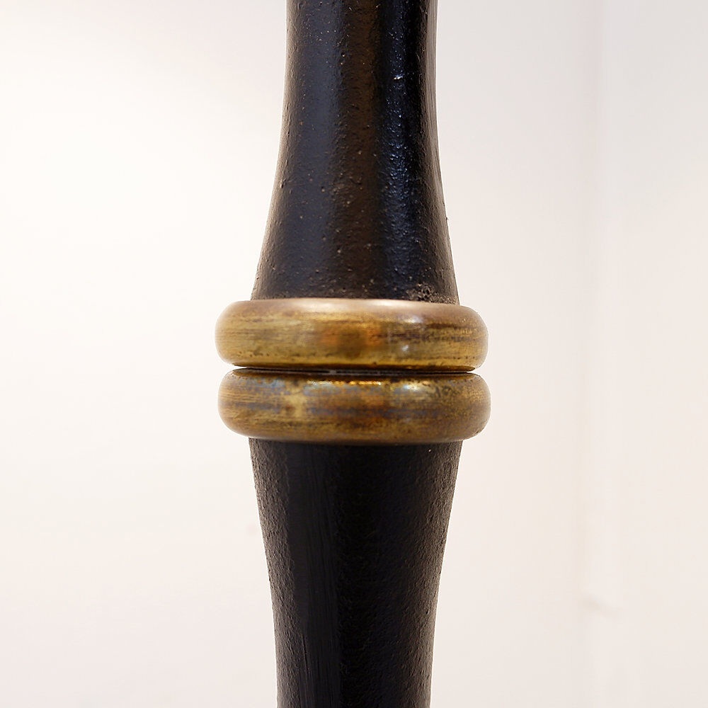 Tripod floor lamp in wrought iron and brass with bamboo-style base.