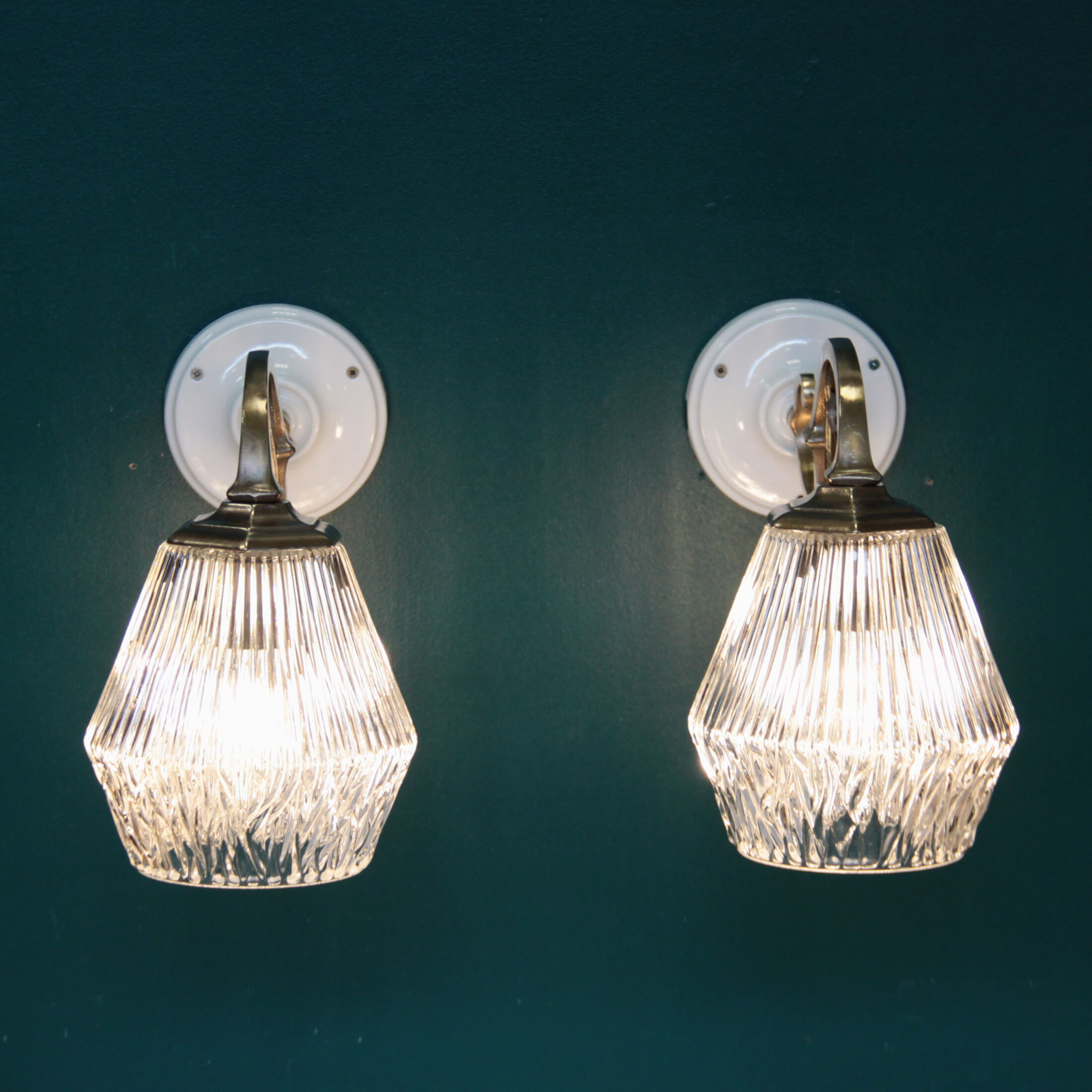 Pair of brass gooseneck wall sconces and glass globe vintage porcelain rosette