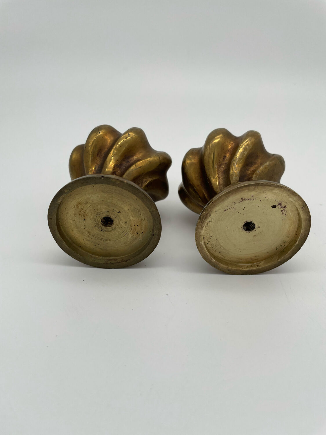 Pair of antique flame curtain rod finials in gilded bronze