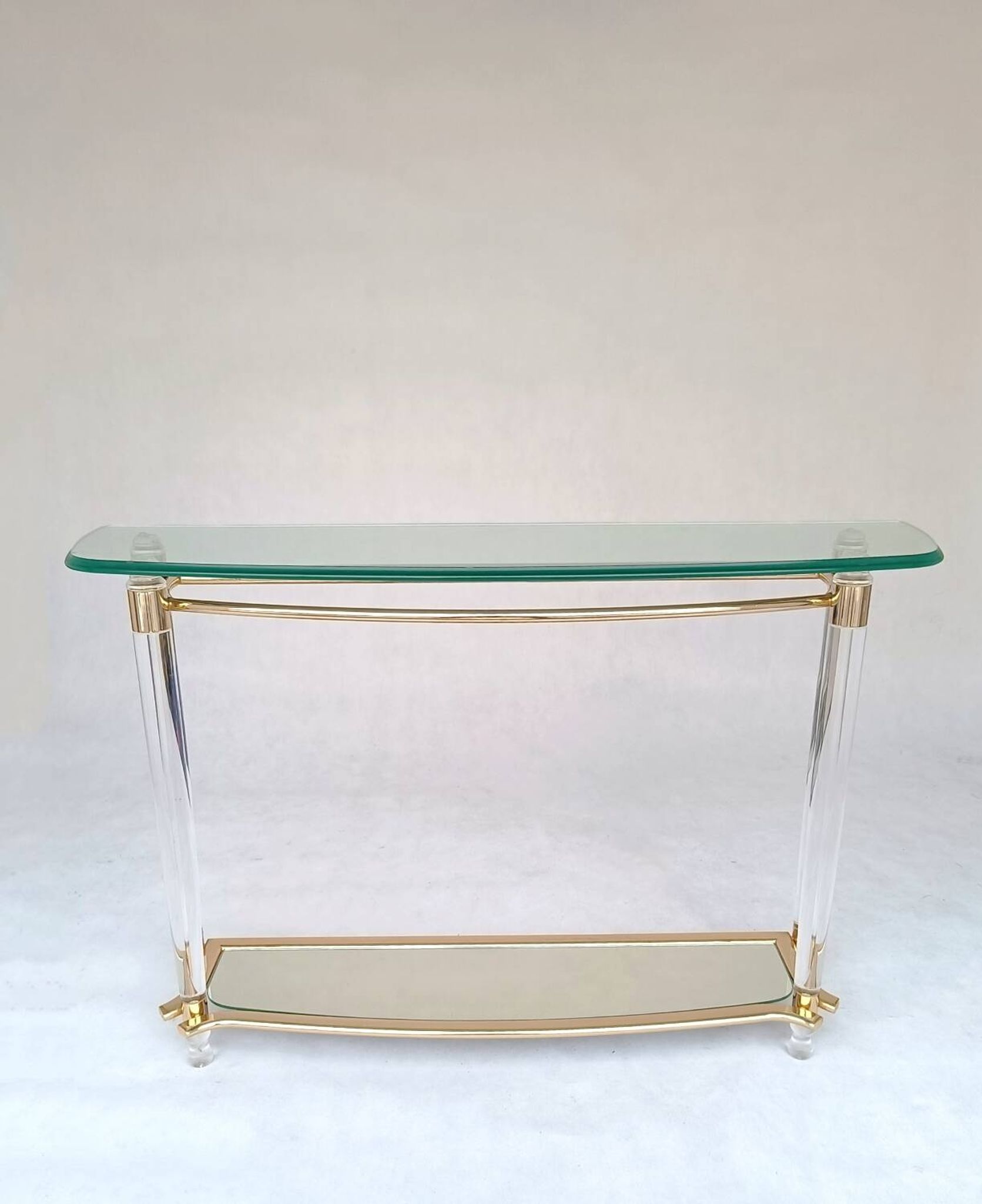 Hollywood Regency console table in lucite, glass and gold metal. 1980s