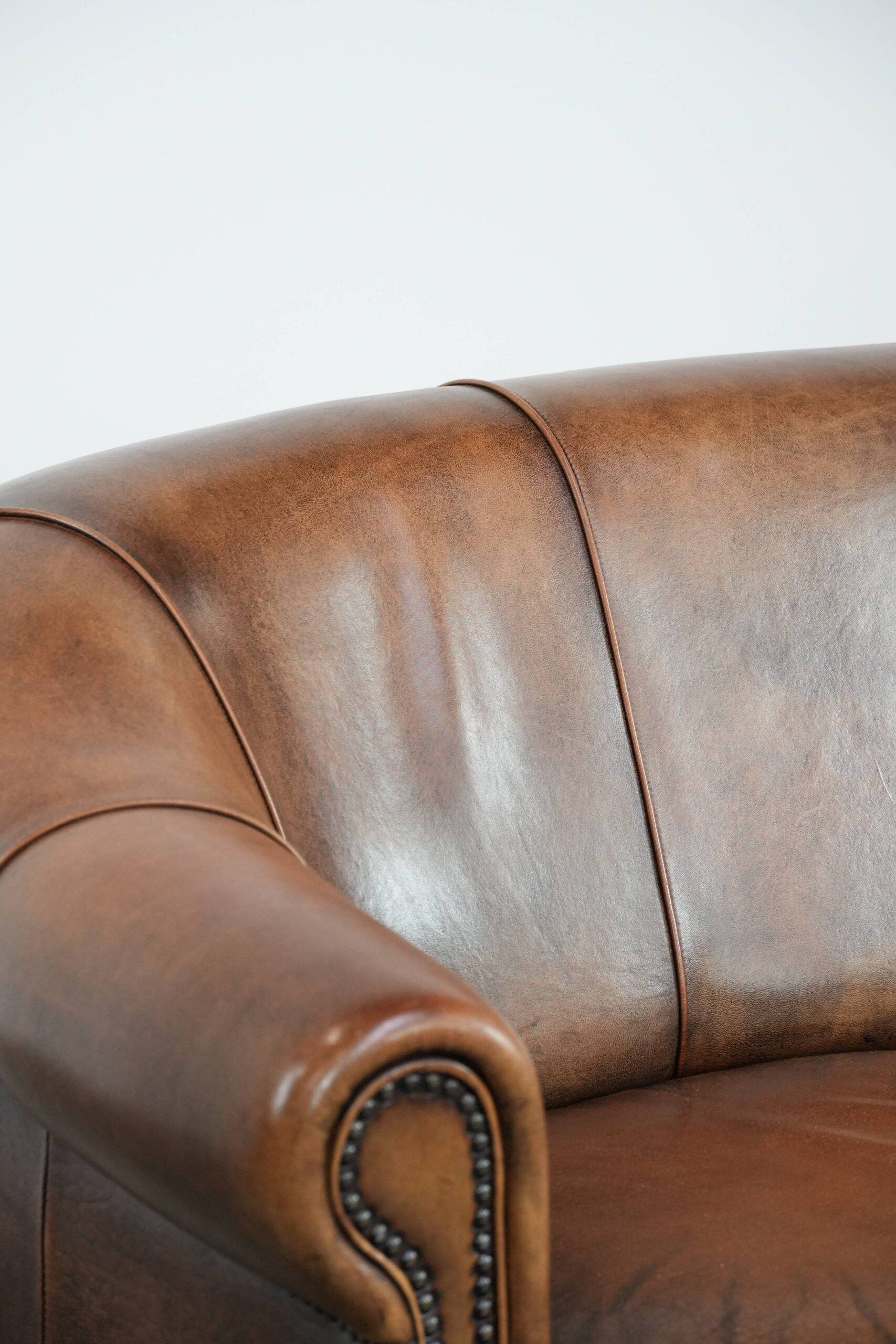 Characterful vintage sturdy 2-seater club sofa made of sheepskin leather