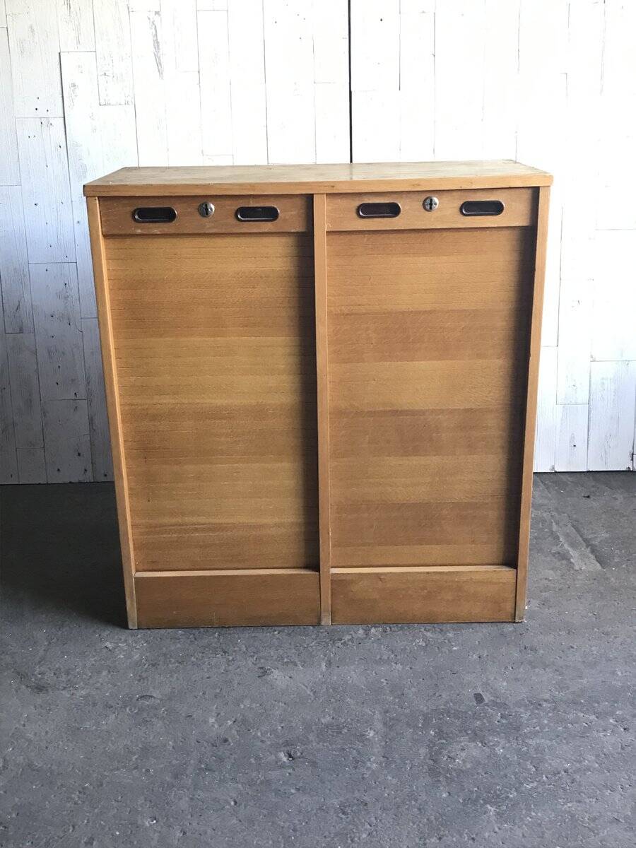 Mid-century industrial haberdashery cabinet in brown oak, double tambour, 1950s.
