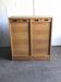 Mid-century industrial haberdashery cabinet in brown oak, double tambour, 1950s.