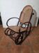 Curved wooden rocking chair with caning