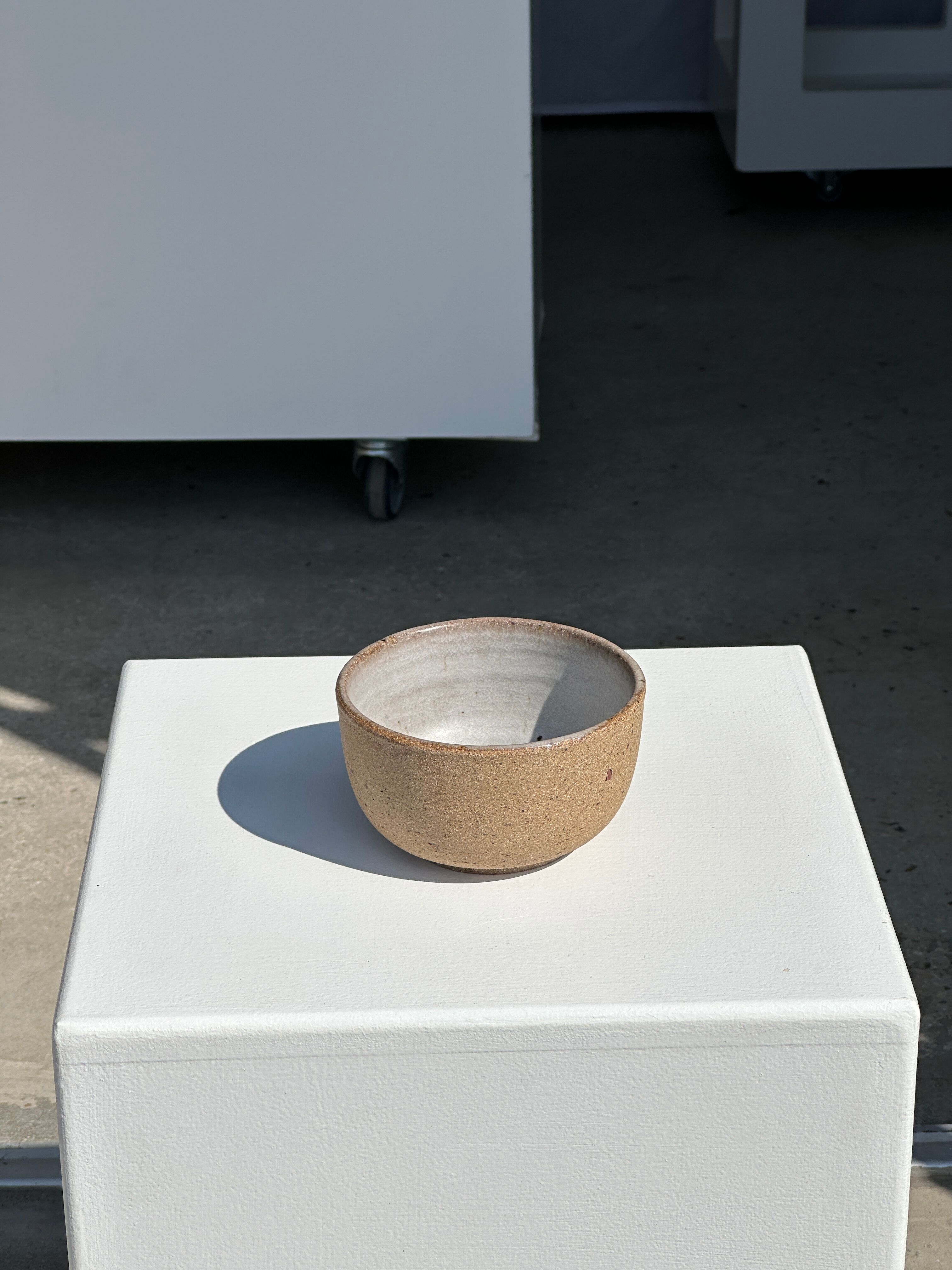 Small brown bowl inside blue and white