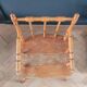 Antique wooden child's armchair from the early 20th century.