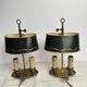 A pair of old brass bed warmers.