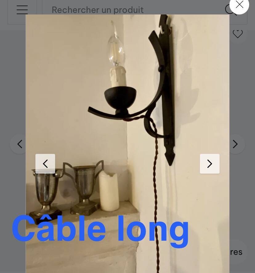 Two wrought iron wall lights, fabric cable.