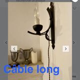 Two wrought iron wall lights, fabric cable.