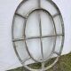Bull's-eye window from the 19th century in iron (with opening).